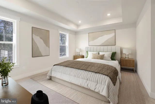 a bedroom with a large bed and a potted plant