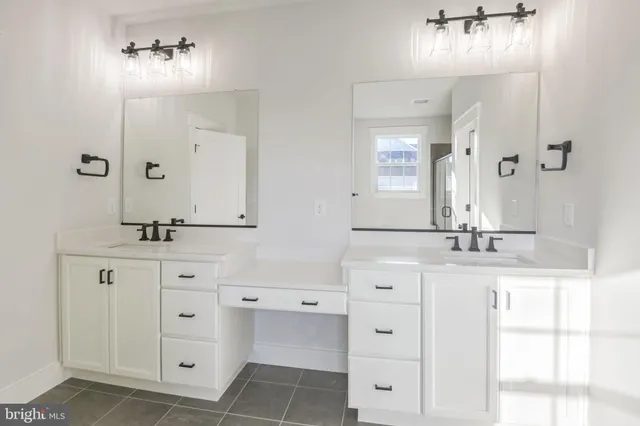 a bathroom with double vanity sink and mirror