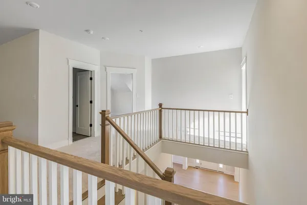 a view of staircase with railing and a window