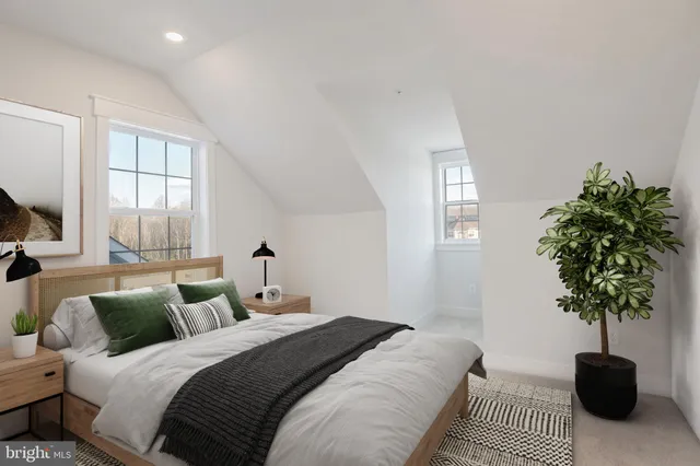 a bedroom with a bed and a potted plant