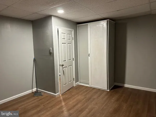 an empty room with wooden floor and a window