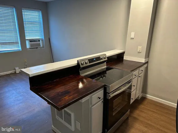 a stove top oven sitting inside of a kitchen