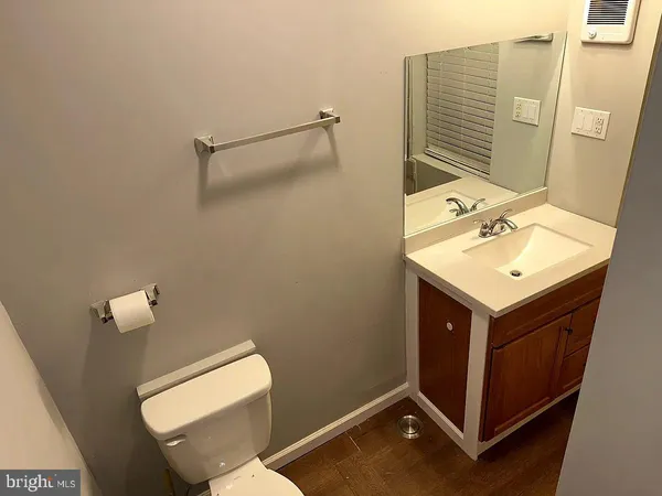a bathroom with a sink mirror vanity and toilet