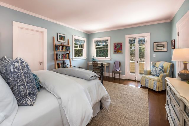 a spacious bedroom with a bed a couch and a bookshelf