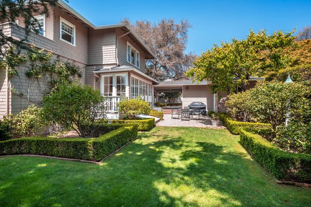 a front view of a house with swimming pool having outdoor seating