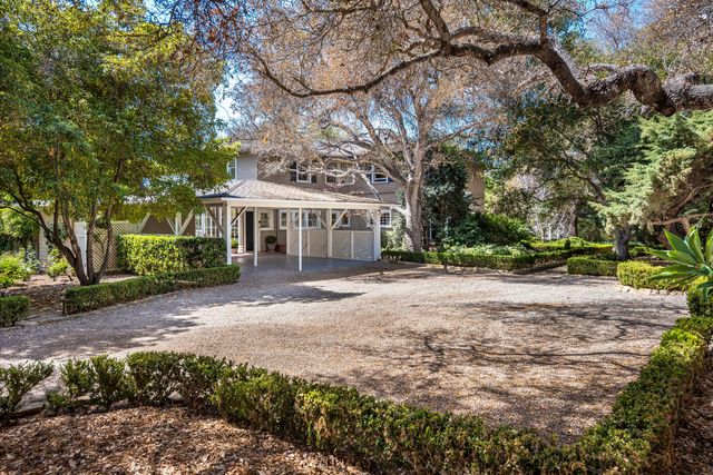 a view of a house with a yard and tree s