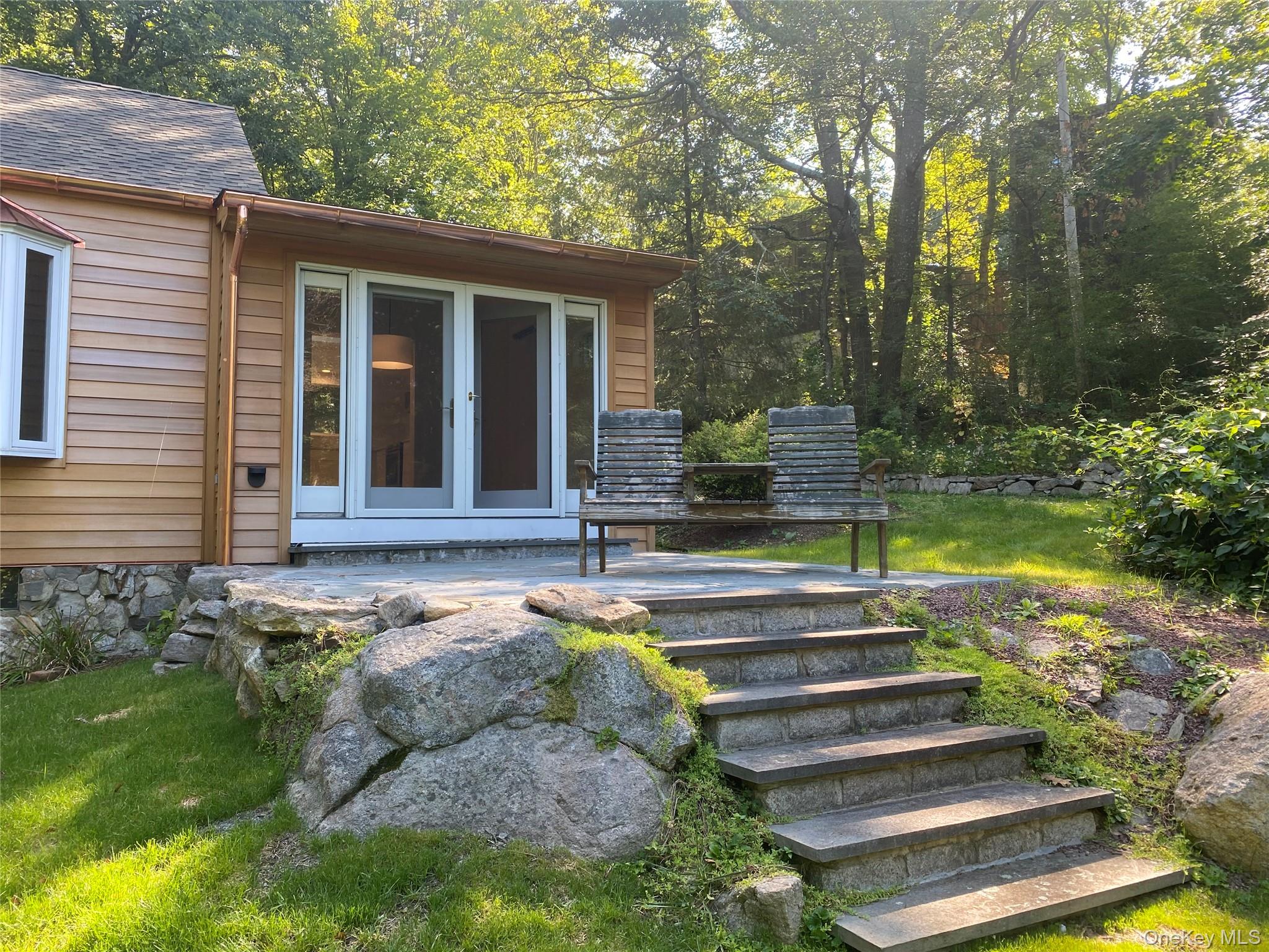 98 Travis Corners Road Garrison, NY 10524 - Photo 16 of 17 Property entrance with french doors, a patio area, and a yard