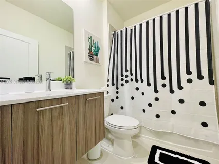 a white toilet sitting next to a white sink