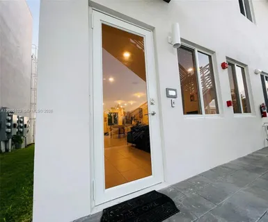 a view of a hallway with a livingroom and furniture
