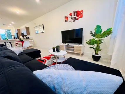 a living room with furniture and a flat screen tv