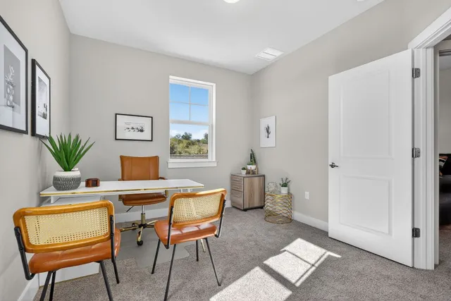 a view of a balcony with chairs and wooden floor