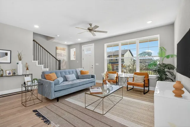 a living room with furniture and a large window