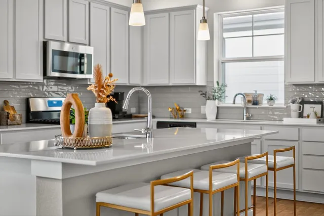 a kitchen with a sink cabinets and window
