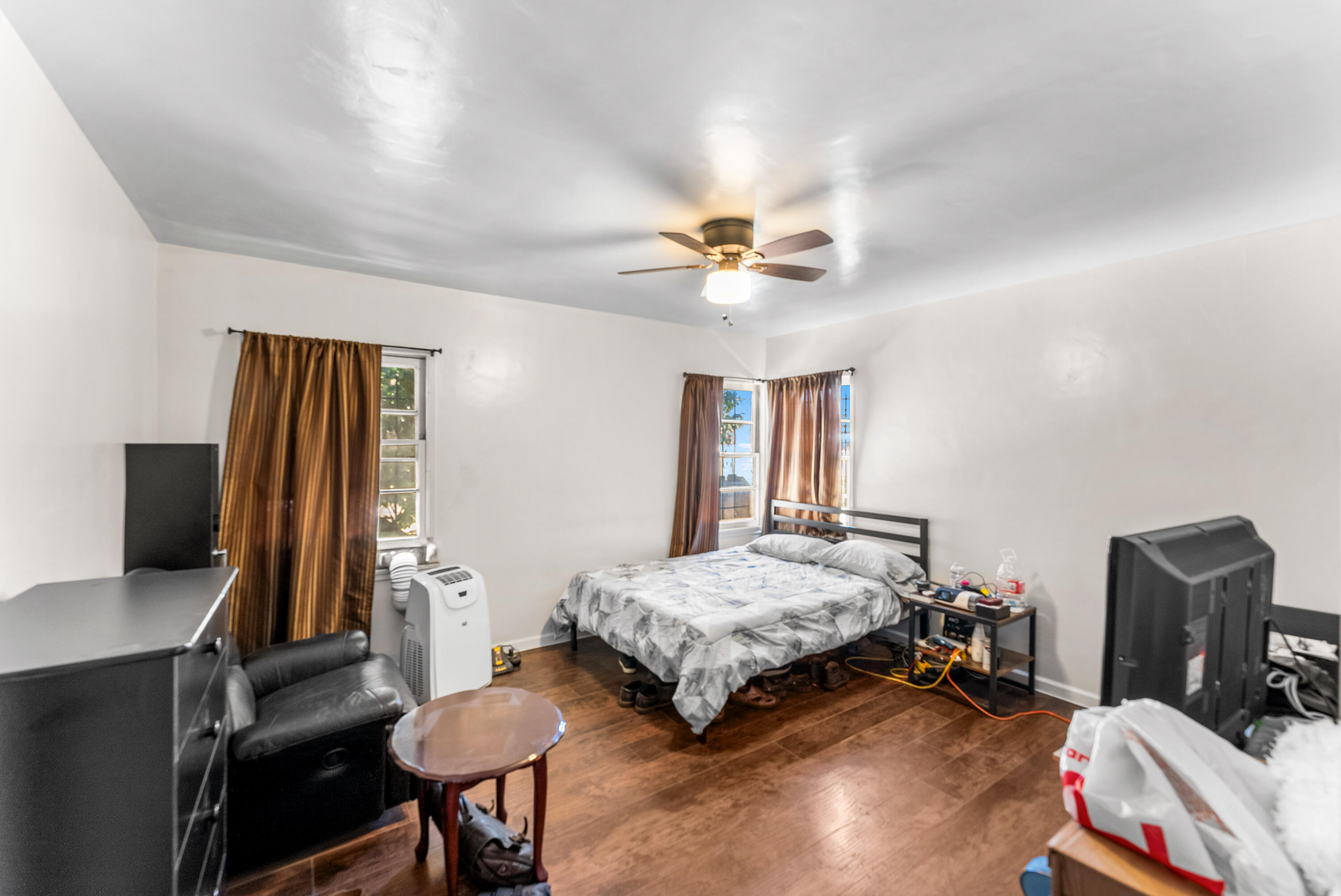 620 South Chester Avenue Compton, CA 90221 - Photo 21 of 32 a bedroom with a bed and a flat screen tv