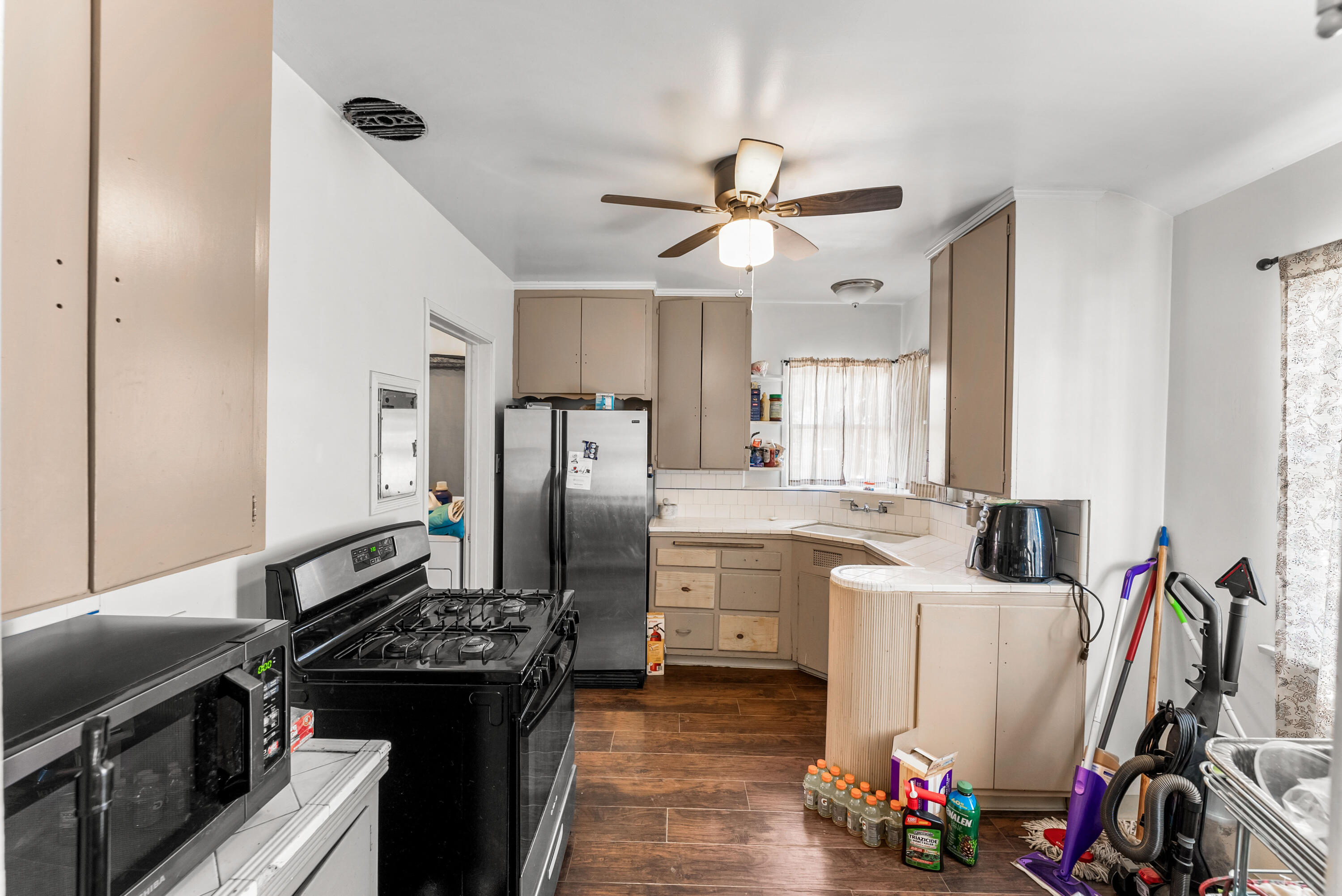 620 South Chester Avenue Compton, CA 90221 - Photo 10 of 32 a kitchen with stainless steel appliances a sink stove and refrigerator