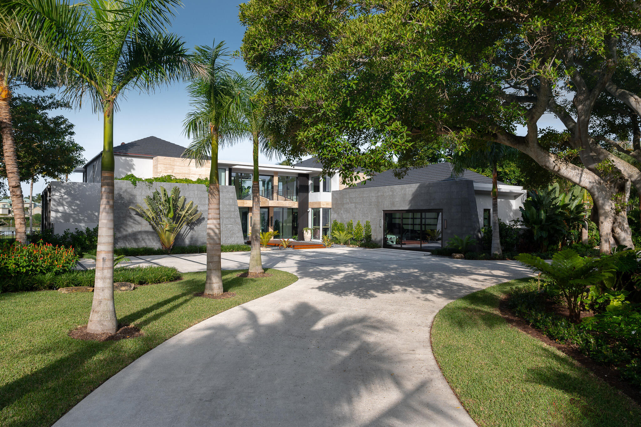 488 South Beach Road Jupiter Island, FL 33455 - Photo 4 of 54 a view of a house with backyard and a patio
