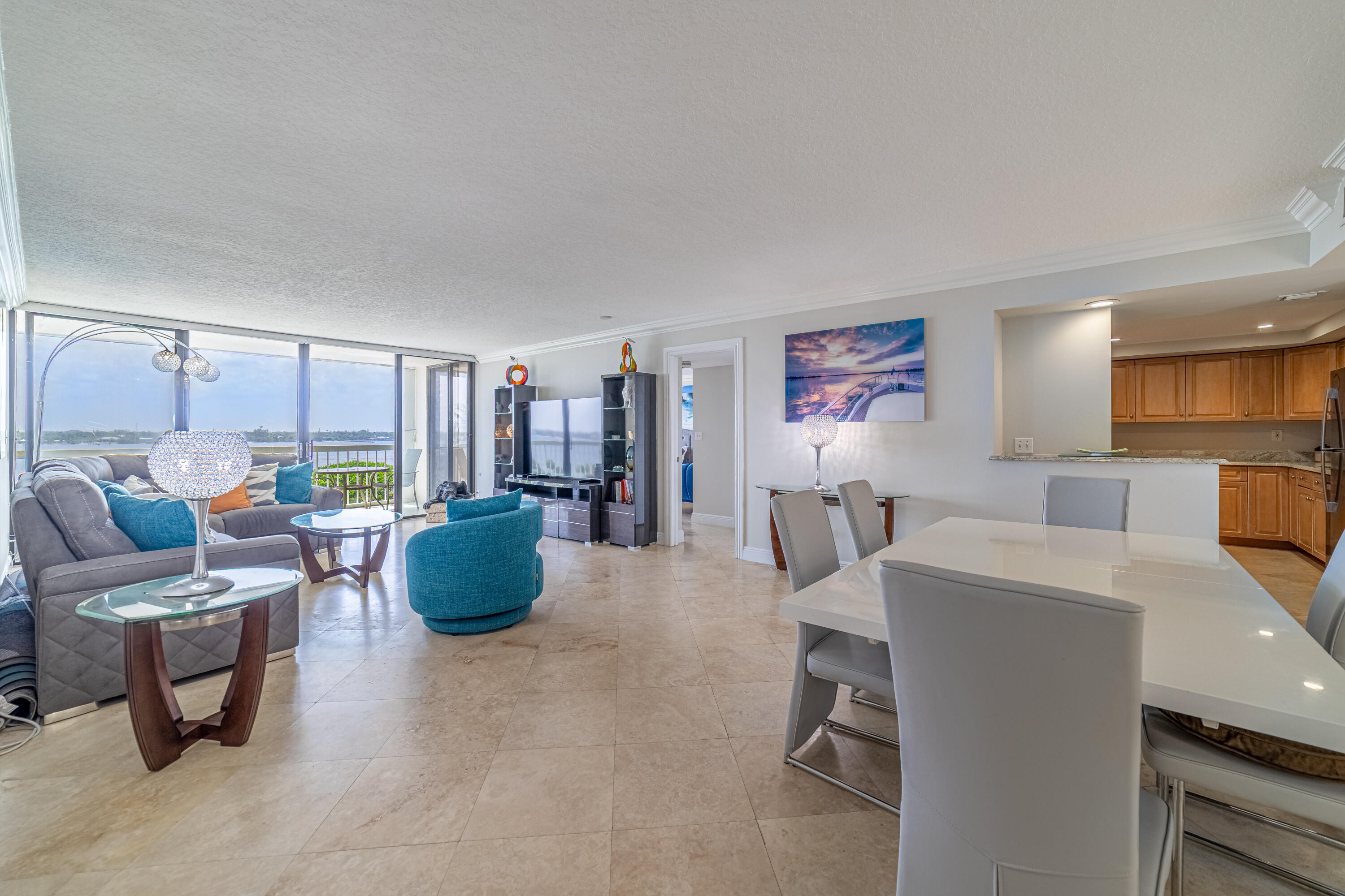 3250 South Ocean Boulevard, Unit 507N Palm Beach, FL 33480 - Photo 25 of 56 a living room with furniture a large window and a table