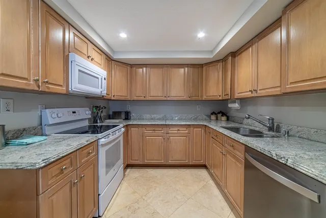 a bedroom with bed and a large window