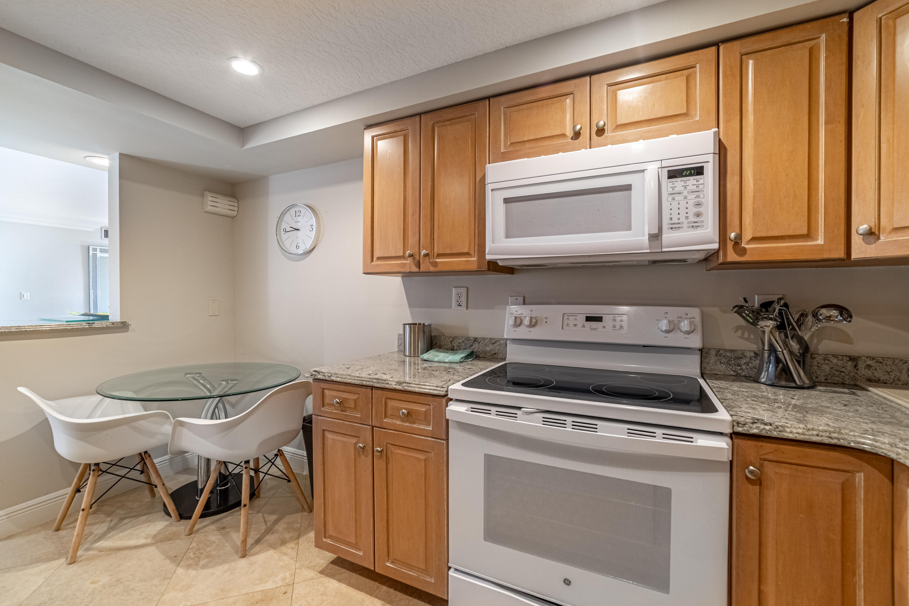 3250 South Ocean Boulevard, Unit 507N Palm Beach, FL 33480 - Photo 31 of 56 a kitchen with stainless steel appliances granite countertop a stove a sink and a microwave