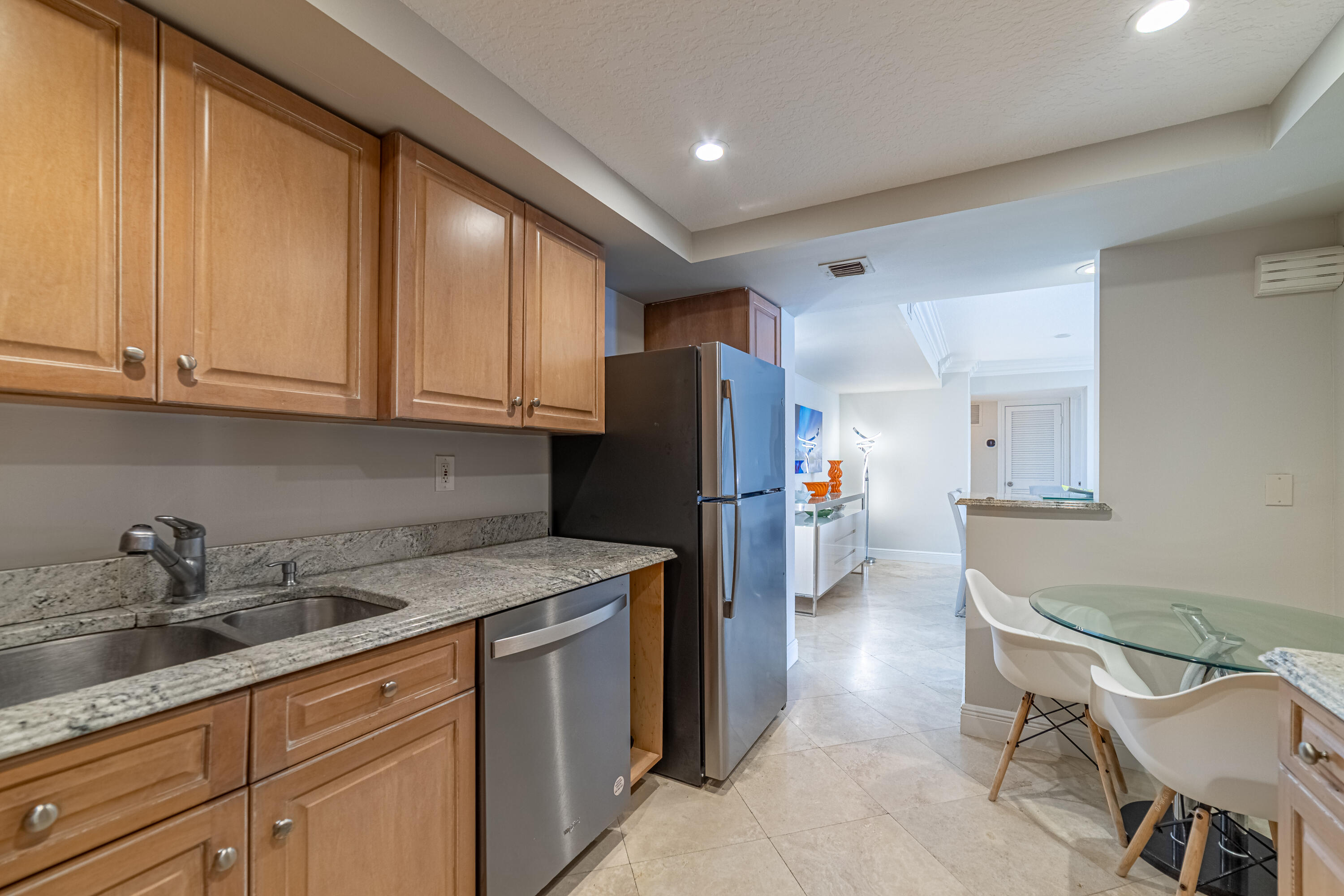 3250 South Ocean Boulevard, Unit 507N Palm Beach, FL 33480 - Photo 32 of 56 a kitchen with a sink a refrigerator and cabinets