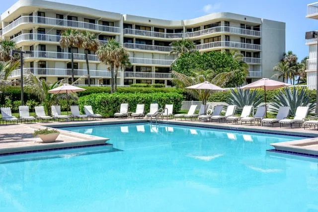 a swimming pool with outdoor seating and yard