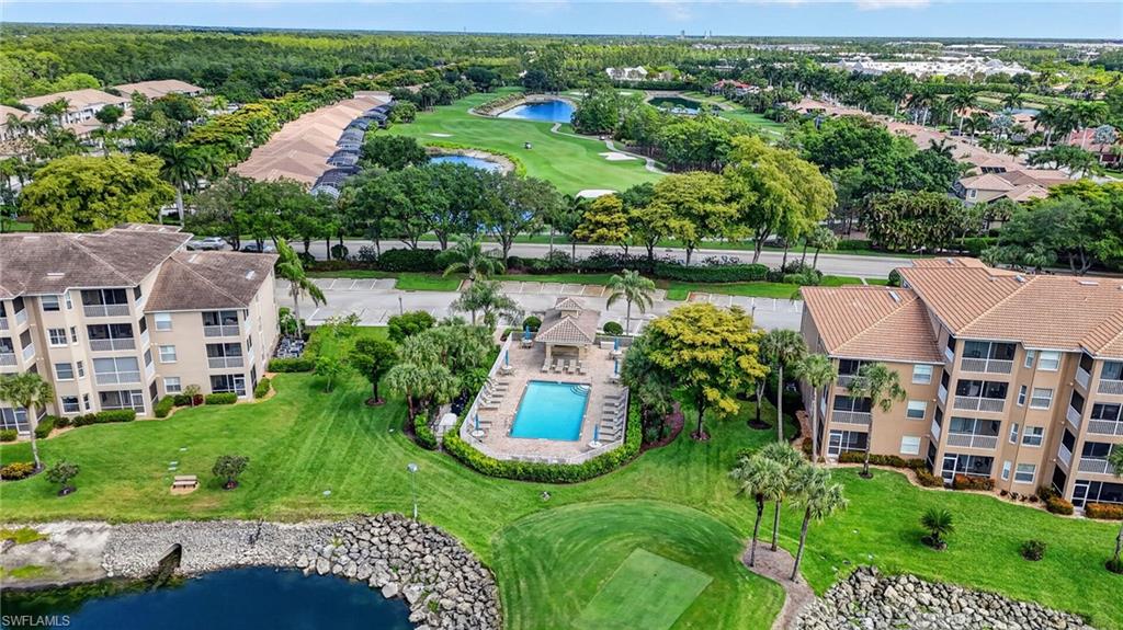 3830 Sawgrass Way, Unit 2922 Naples, FL 34112 - Photo 13 of 43 an aerial view of house with yard and lake view