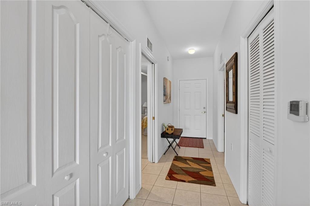 3830 Sawgrass Way, Unit 2922 Naples, FL 34112 - Photo 18 of 43 a hallway with a view of living room