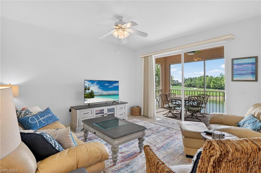 3830 Sawgrass Way, Unit 2922 Naples, FL 34112 - Photo 20 of 43 a living room with furniture and a large window