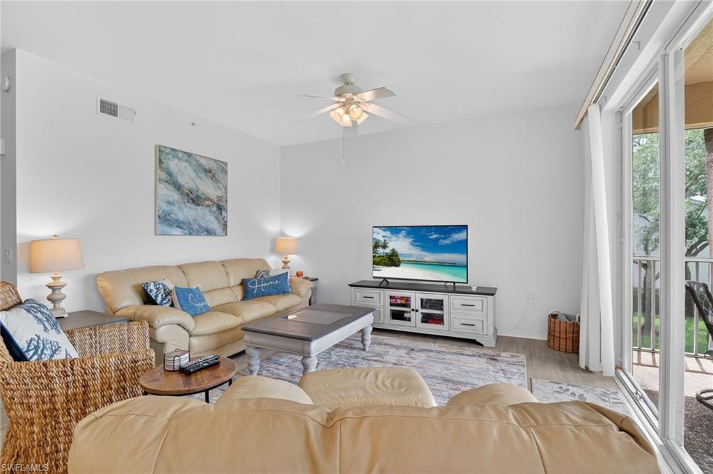 3830 Sawgrass Way, Unit 2922 Naples, FL 34112 - Photo 22 of 43 a living room with furniture a couch and a flat screen tv