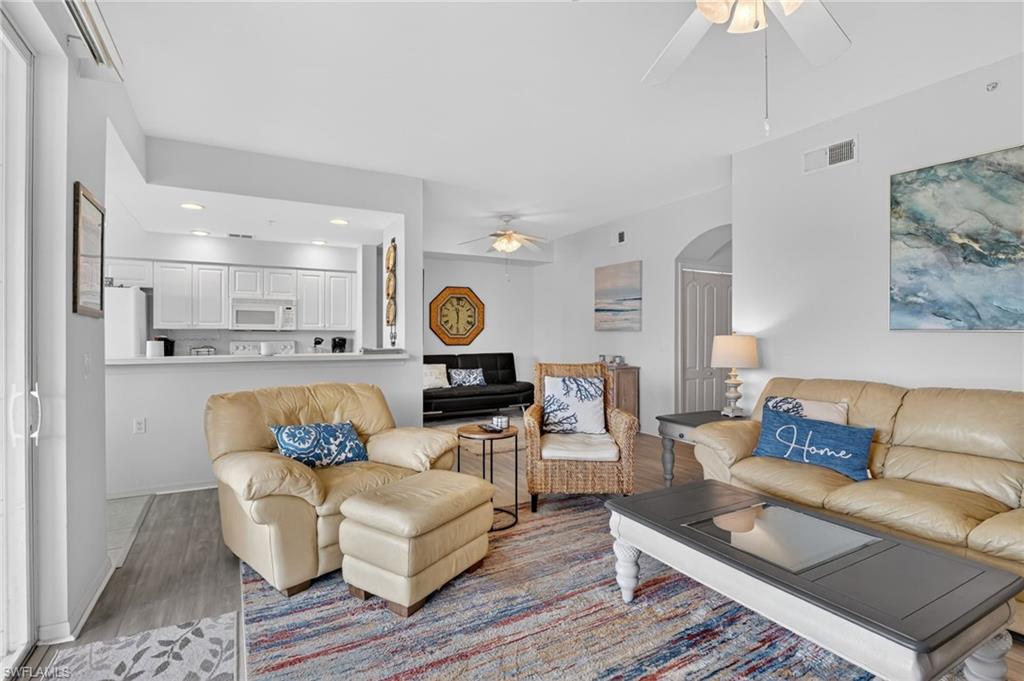 3830 Sawgrass Way, Unit 2922 Naples, FL 34112 - Photo 23 of 43 a living room with furniture and kitchen view