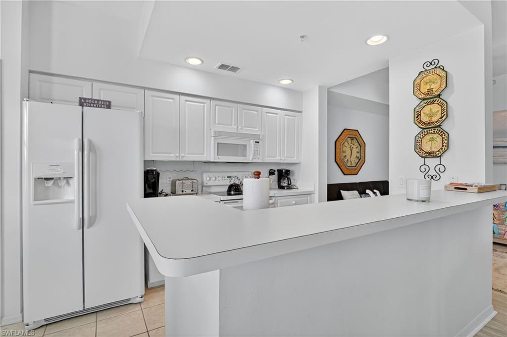 3830 Sawgrass Way, Unit 2922 Naples, FL 34112 - Photo 28 of 43 a view of kitchen with stainless steel appliances granite countertop cabinets and a window