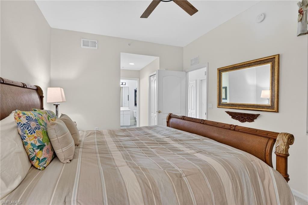 3830 Sawgrass Way, Unit 2922 Naples, FL 34112 - Photo 34 of 43 a bedroom with a bed and a painting on the wall