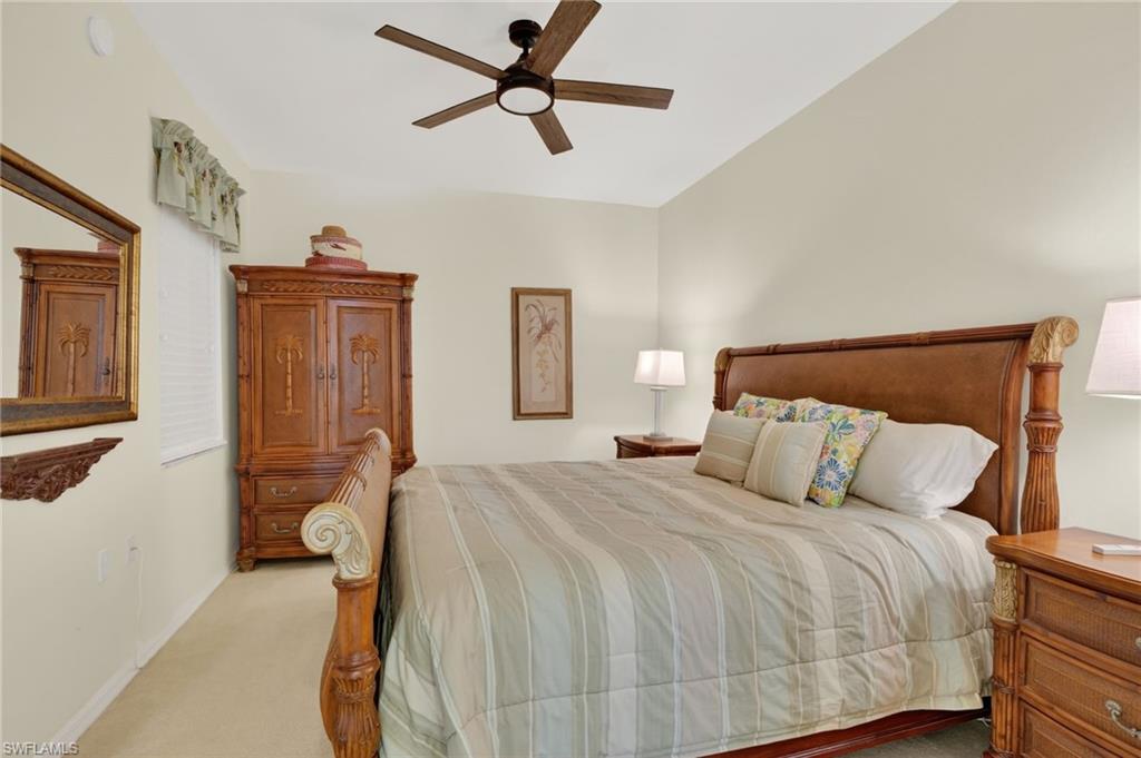 3830 Sawgrass Way, Unit 2922 Naples, FL 34112 - Photo 35 of 43 a bedroom with a bed and cabinets