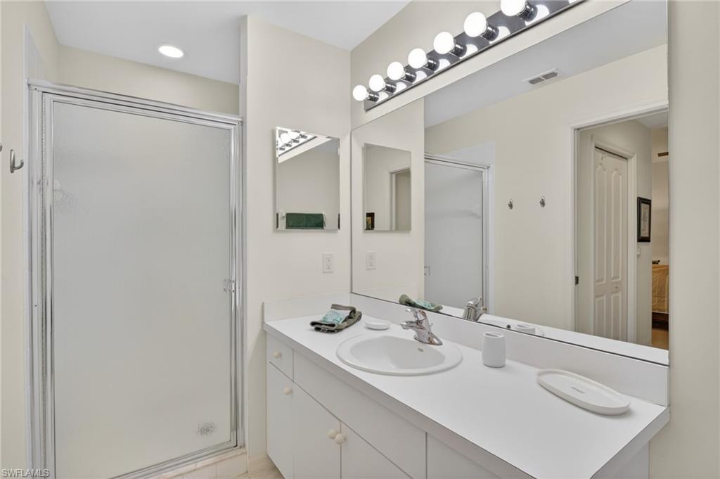 3830 Sawgrass Way, Unit 2922 Naples, FL 34112 - Photo 36 of 43 a bathroom with a sink double vanity and a mirror