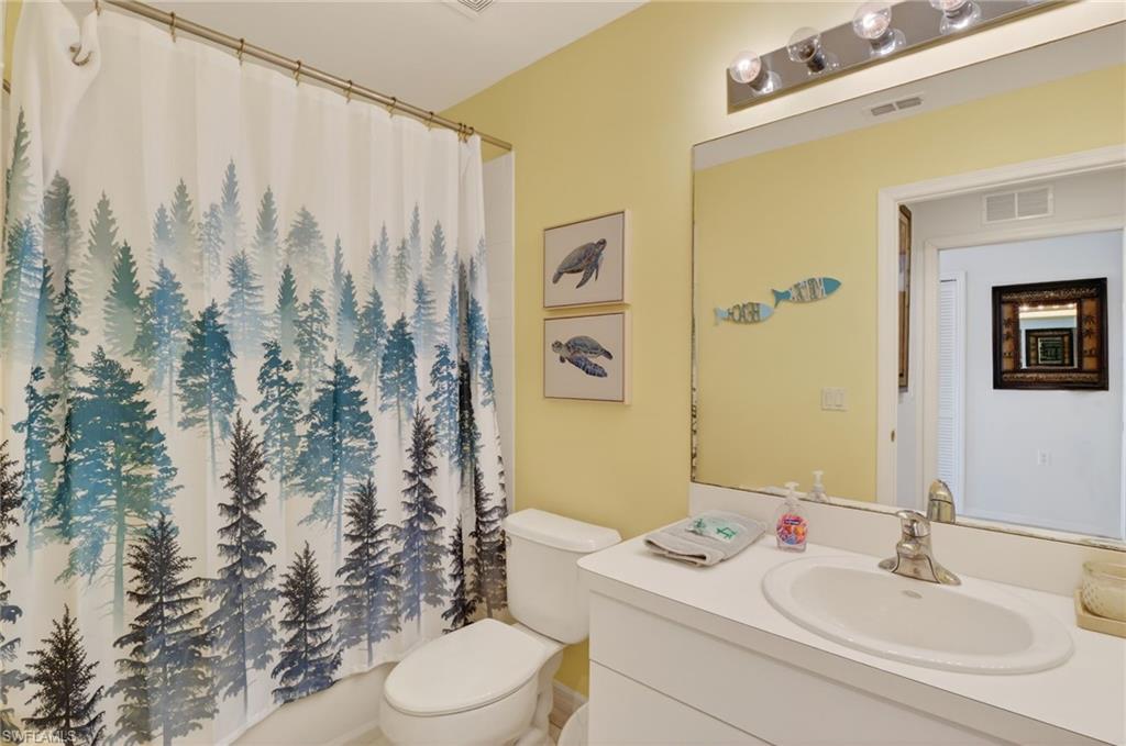 3830 Sawgrass Way, Unit 2922 Naples, FL 34112 - Photo 40 of 43 a bathroom with a sink toilet and shower