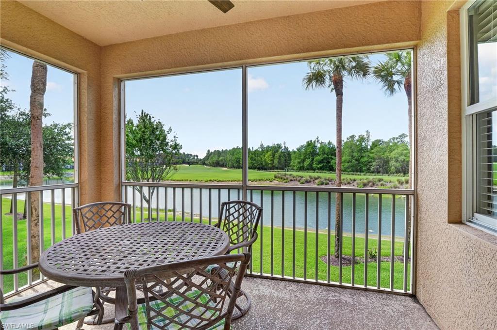 3830 Sawgrass Way, Unit 2922 Naples, FL 34112 - Photo 42 of 43 a view of a patio with a table chairs and a table