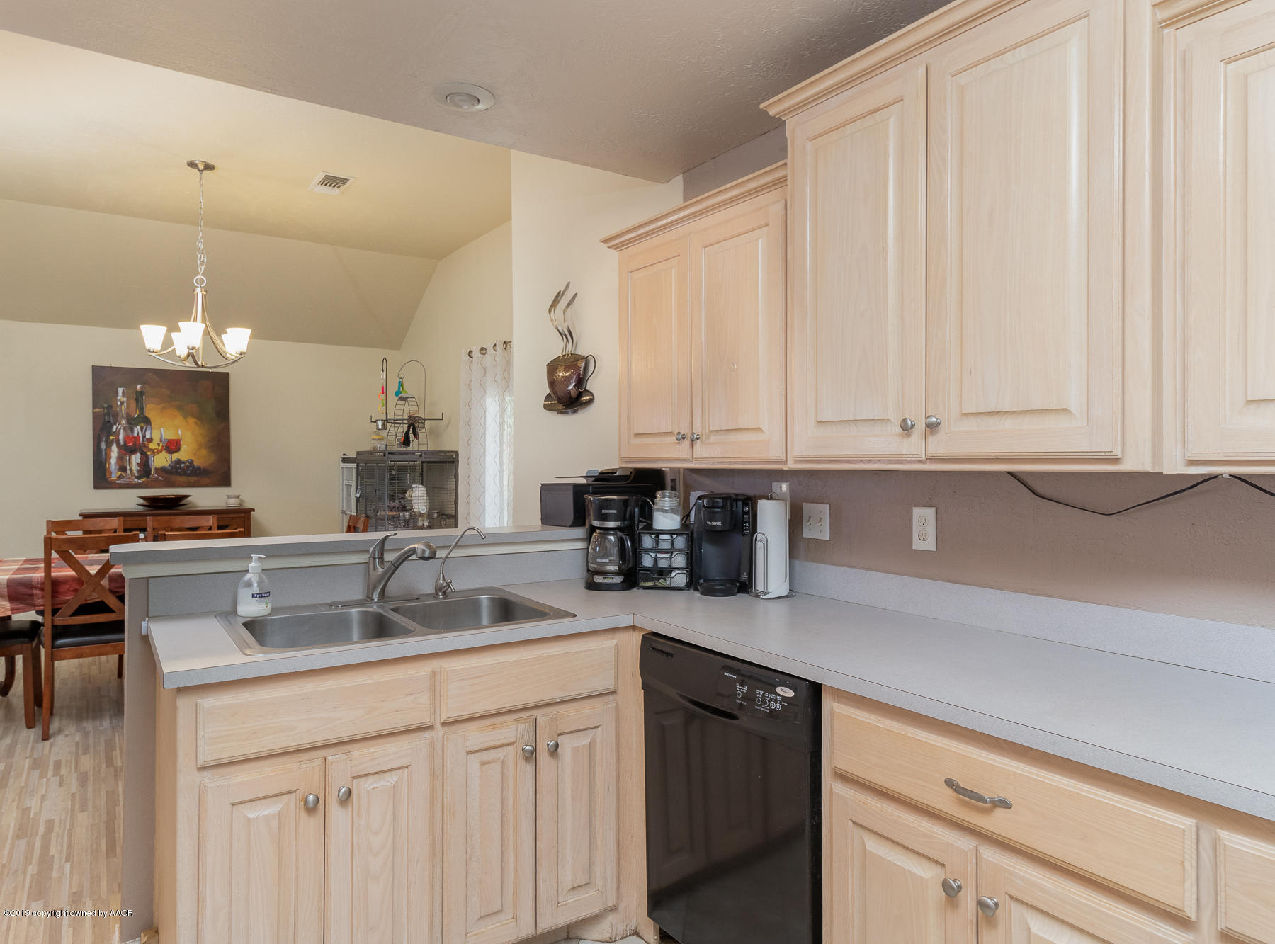 6403 Rally Road Amarillo, TX 79119 - Photo 11 of 24 a kitchen with stainless steel appliances granite countertop white cabinets sink and dishwasher