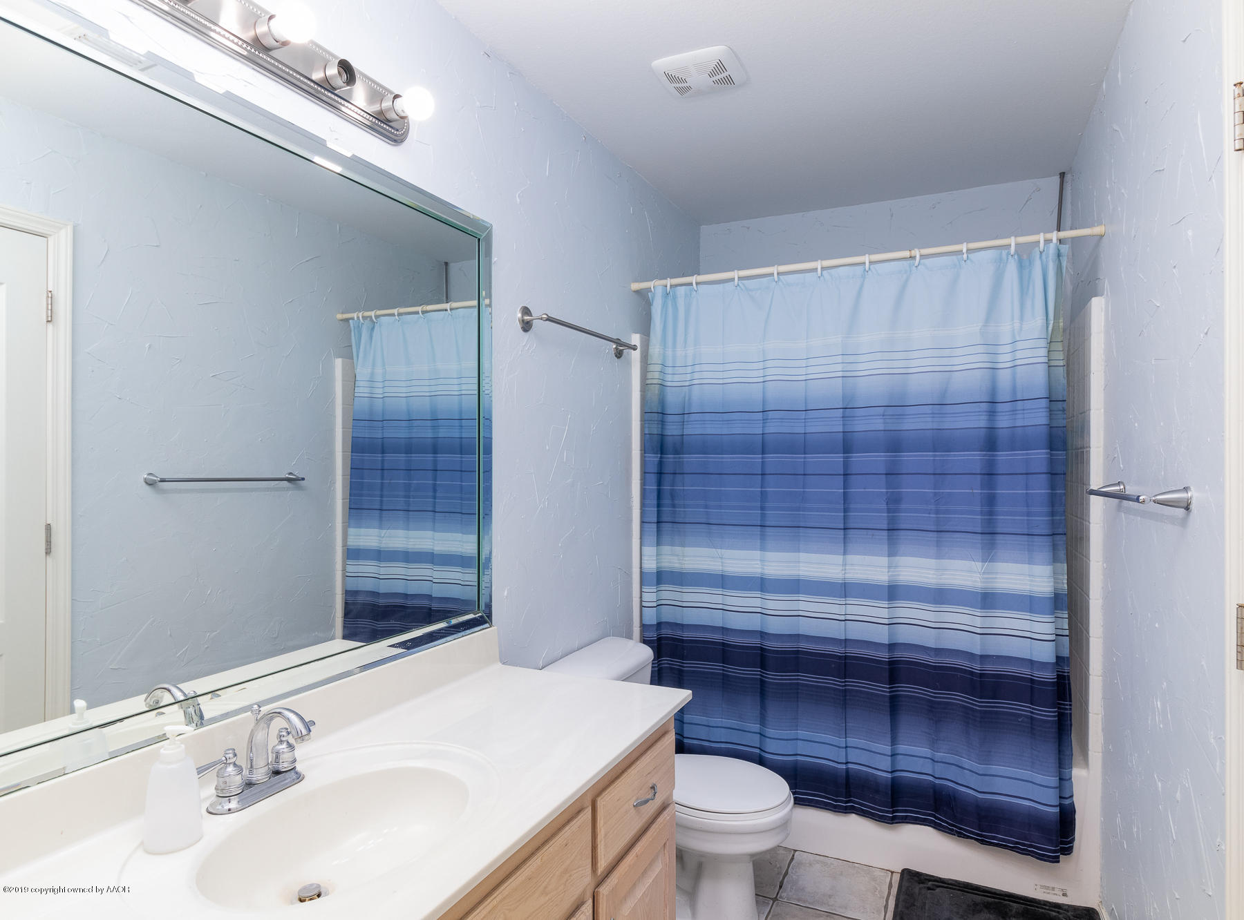 6403 Rally Road Amarillo, TX 79119 - Photo 18 of 24 a bathroom with a sink a toilet and shower
