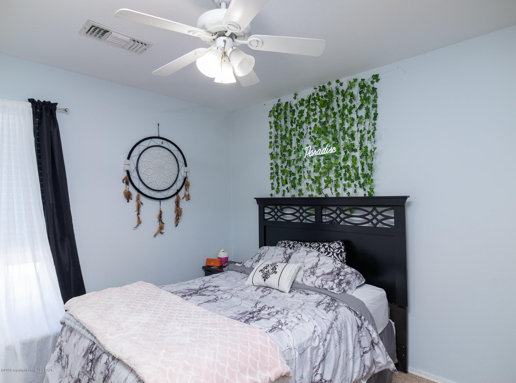 6403 Rally Road Amarillo, TX 79119 - Photo 19 of 24 a bedroom with a bed and a chandelier