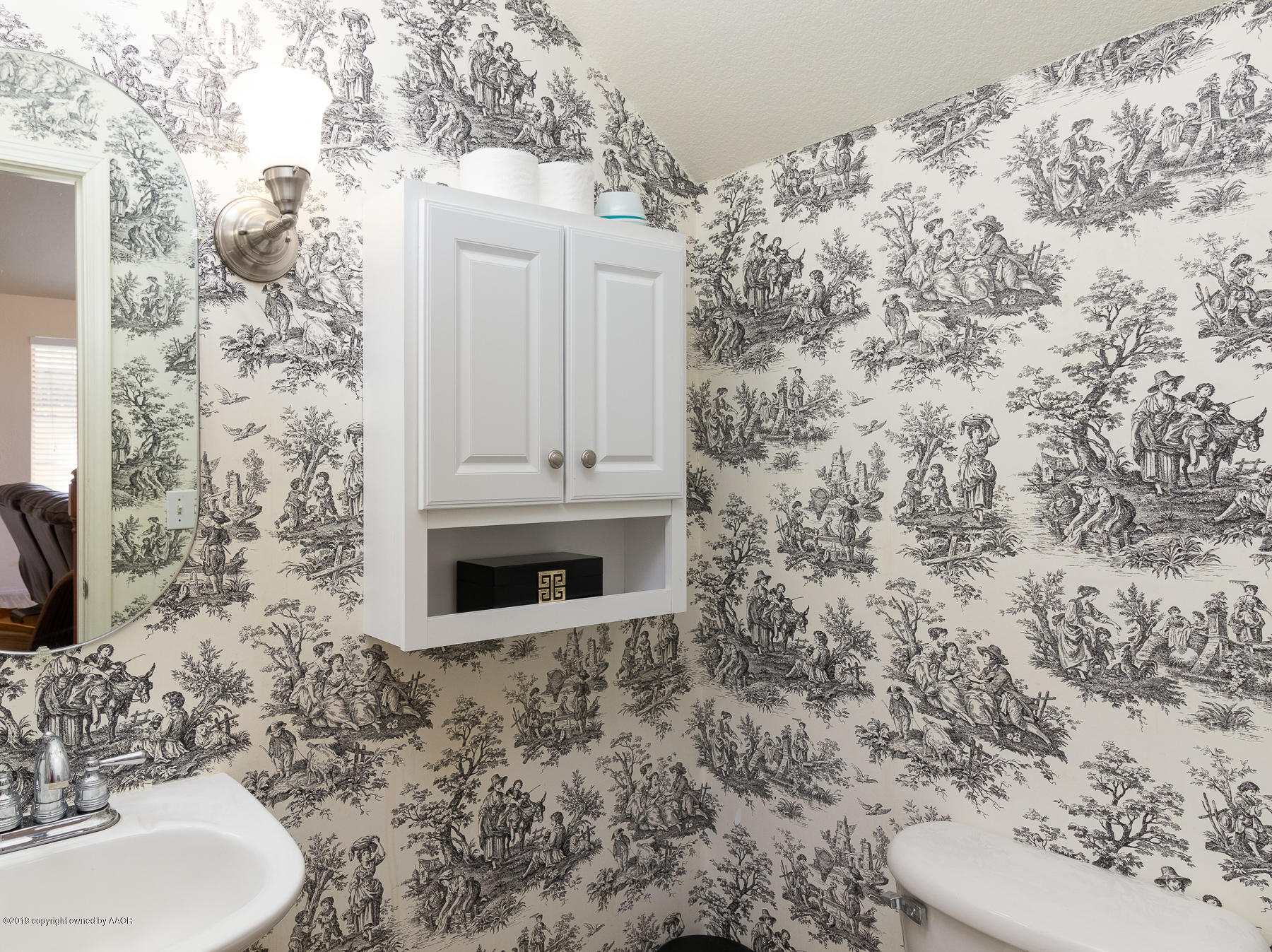 6403 Rally Road Amarillo, TX 79119 - Photo 21 of 24 a bathroom with a toilet and a sink