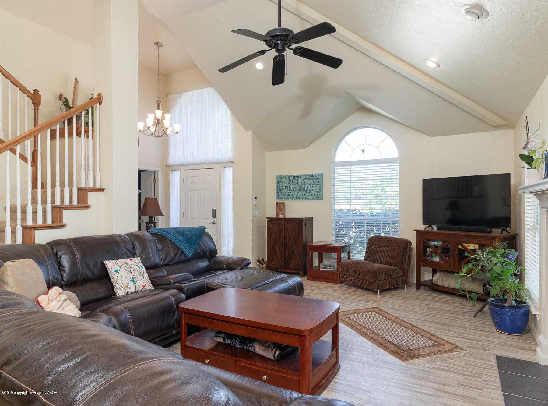 6403 Rally Road Amarillo, TX 79119 - Photo 7 of 24 a living room with furniture a flat screen tv and a large window