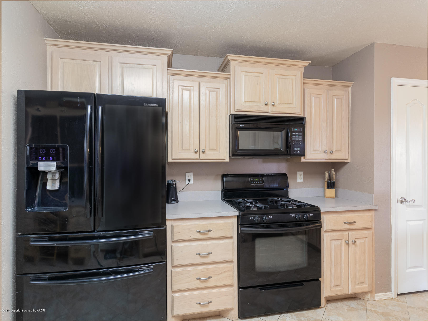 6403 Rally Road Amarillo, TX 79119 - Photo 10 of 24 a kitchen with white cabinets and stainless steel appliances