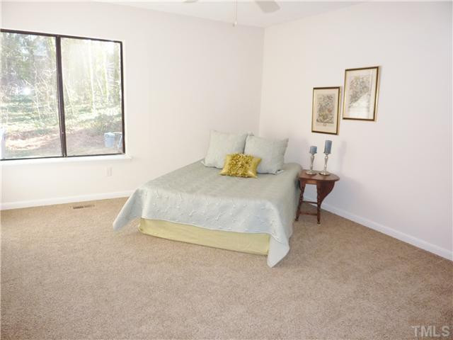 824 Green Ridge Drive Raleigh, NC 27609 - Photo 7 of 17 a bedroom with a bed and next to a window
