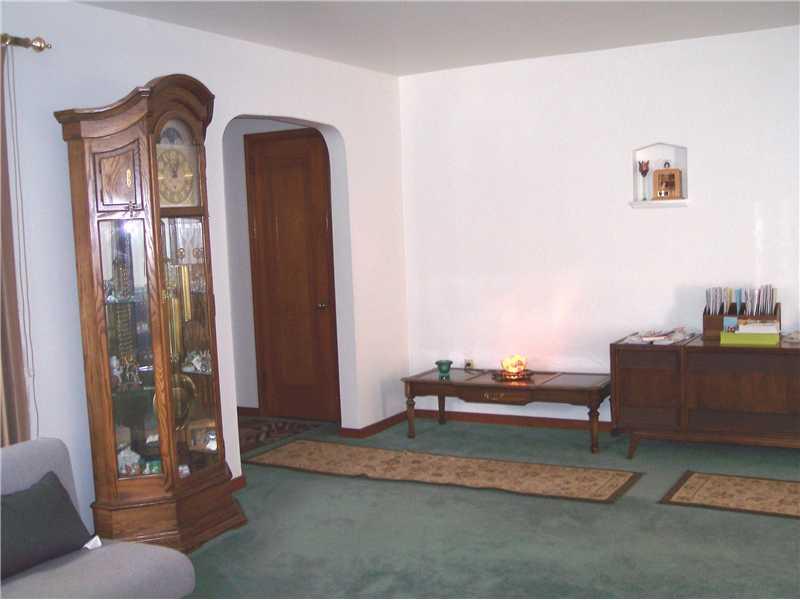 Living Room. Another view of living room leading to front door.