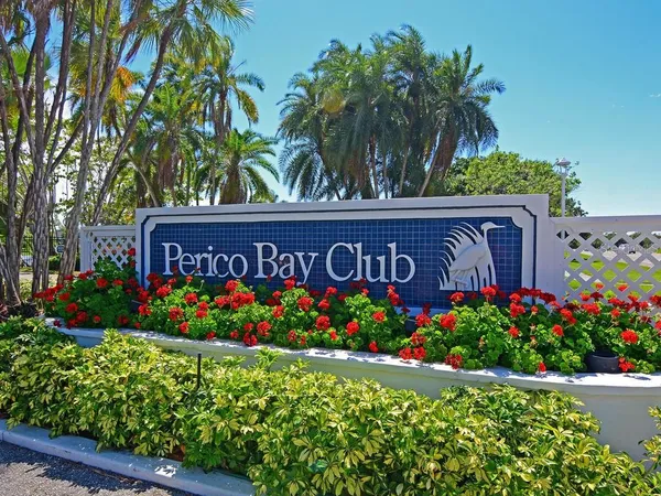 a view of sign board with potted plants