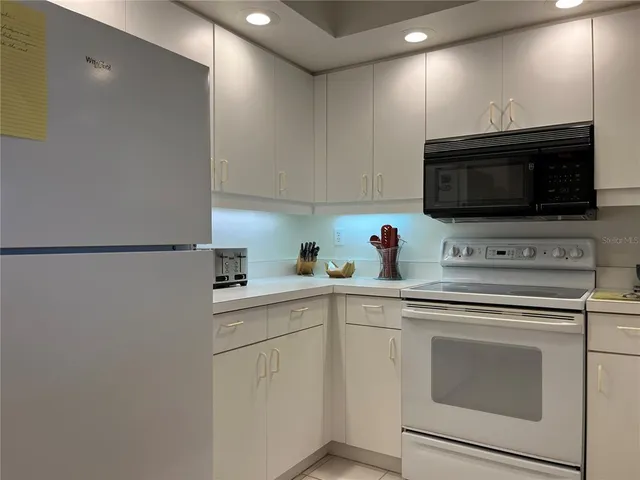 a kitchen with a sink stove and microwave
