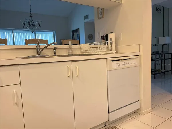 a kitchen with stainless steel appliances granite countertop a sink a stove a refrigerator and cabinets