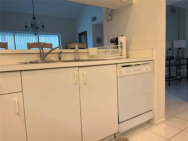 a kitchen with stainless steel appliances granite countertop a sink a stove a refrigerator and cabinets