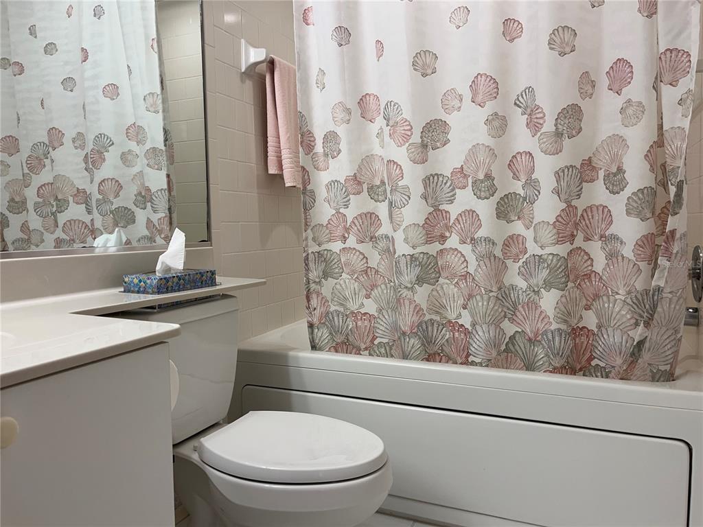 1397 Perico Point Circle, Unit 1397 Bradenton, FL 34209 - Photo 14 of 39 a bathroom with a toilet and a shower curtain