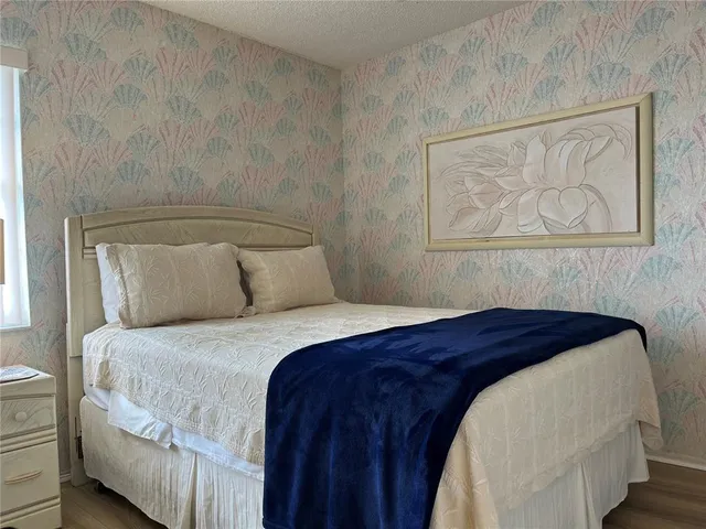 a bedroom with a bed and wall painting